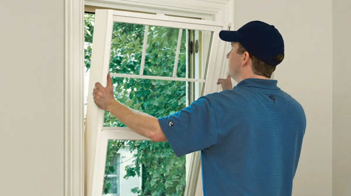 Professional contractors performing a residential window insulation and replacement service in Colorado Springs, CO